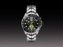 Men's luxury chronograph watch with black dial, silver band, and yellow accents on bezel and hands